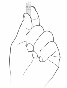 Hand holding, and tapping Alkindi Sprinkle capsule.