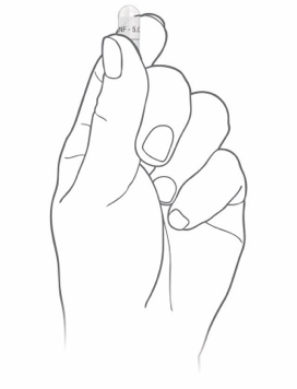 Hand squeezing Alkindi Sprinkle capsule from the bottom.